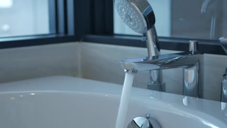 POV-to-the-water-flow-out-into-the-bathtub-relaxation-spa-time