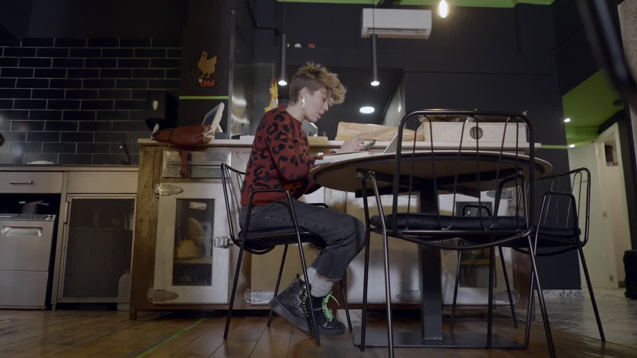 Woman Working in a Trendy Cafe