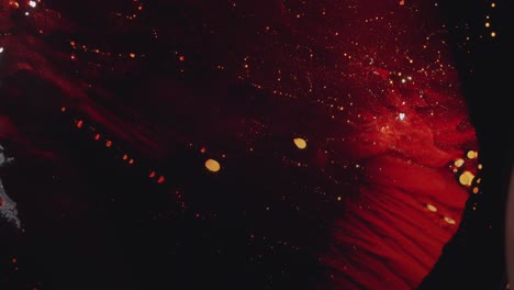 fotografía macro de sustancia acuosa de color rojo claro que forma formas impresionantes