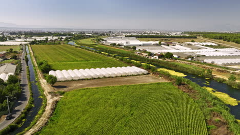 Antalya-Turkey-Aerial-v53-drone-fly-along-düden-stream-capturing-yenigöl-neighborhood-with-green-open-farmland-and-controlled-environment-greenhouse-structures---Shot-with-Mavic-3-Cine---July-2022