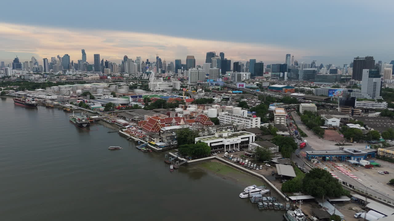 Wat Khlong Toei Nok Pier Near Chao Phraya River In Khlong Toei, Bangkok, Thailand. Aerial Wide Shot