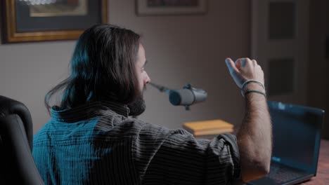 man recording a podcast at home
