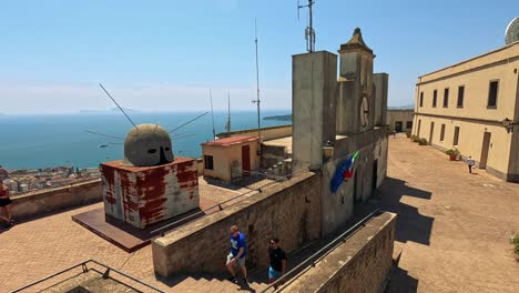 people exploring a historic lookout with sea views