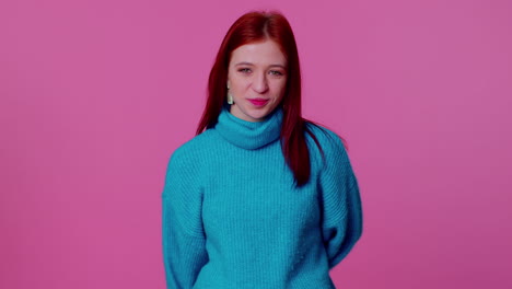 Cheerful lovely teenager student girl fashion model in blue sweater smiling and looking at camera