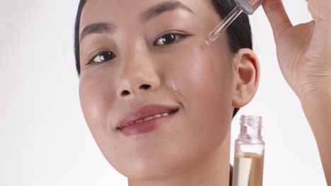 woman applying facial oil