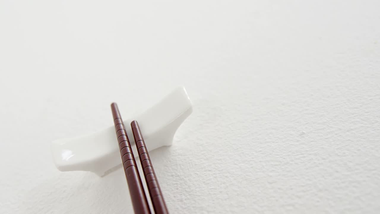 Black chopsticks on a chopstick rest