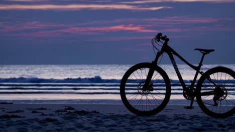 sunrise on the beach with mountain bike silhouette
