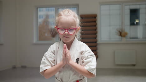 girl in white kimono in martial arts class