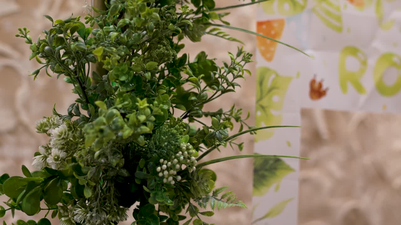 Vibrant greenery enhances rustic decor at a charming outdoor gathering with artistic banners