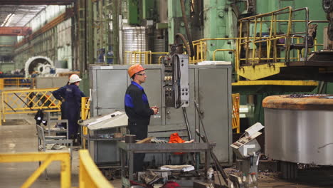 industrial factory workers operating machinery