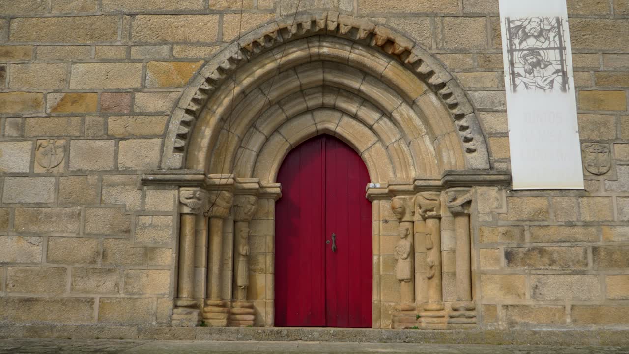 Ancient Stone Church with Red Door and Gothic Arch