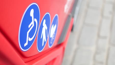 accessibility signs on a red vehicle