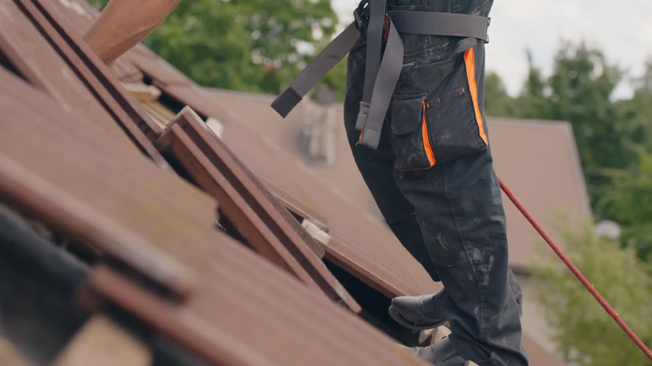 Roofer placing roof tiles on top to prepare solar panel installation, side view