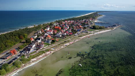 drone shot of kuznica city on hel island with turquoise baltic sea and corals underwater - wide shot