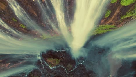 tumpak sewu rainbow waterfalls aerial scenic view reverse timelapse capture, indonesia