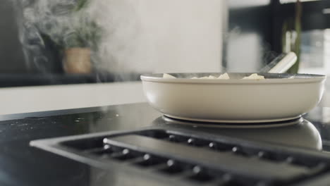 potatoes are fried on a modern induction cooker. built-in extractor works. side view