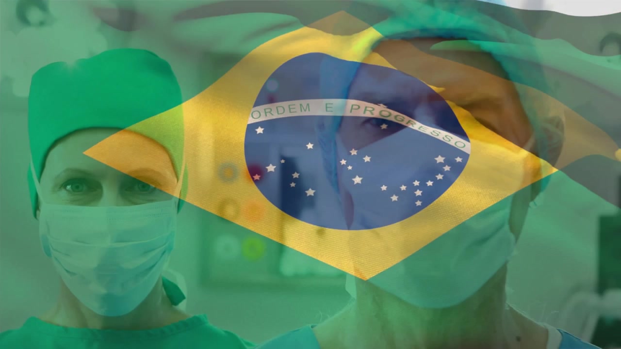 Animação da bandeira do Brasil sobre cirurgiões caucasianos com máscaras faciais