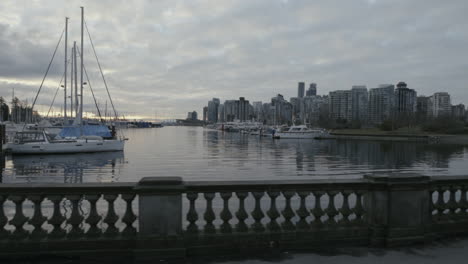 wide dynamic shot of a boats in morning marina, vancouver west end, slowmotion