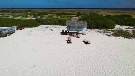 man sunbathing on a caribbean beach of curacao island