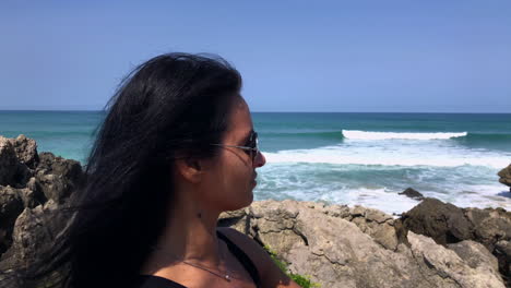 woman enjoying a sunny day on the coast and nice views of the sea and the beach