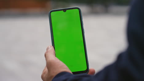 manager hands holding chroma key smartphone outside closeup. man checking sms
