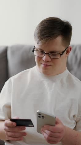 young adult using smartphone and credit card