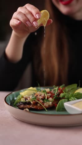 woman enjoying a delicious grilled fish dish with lemon