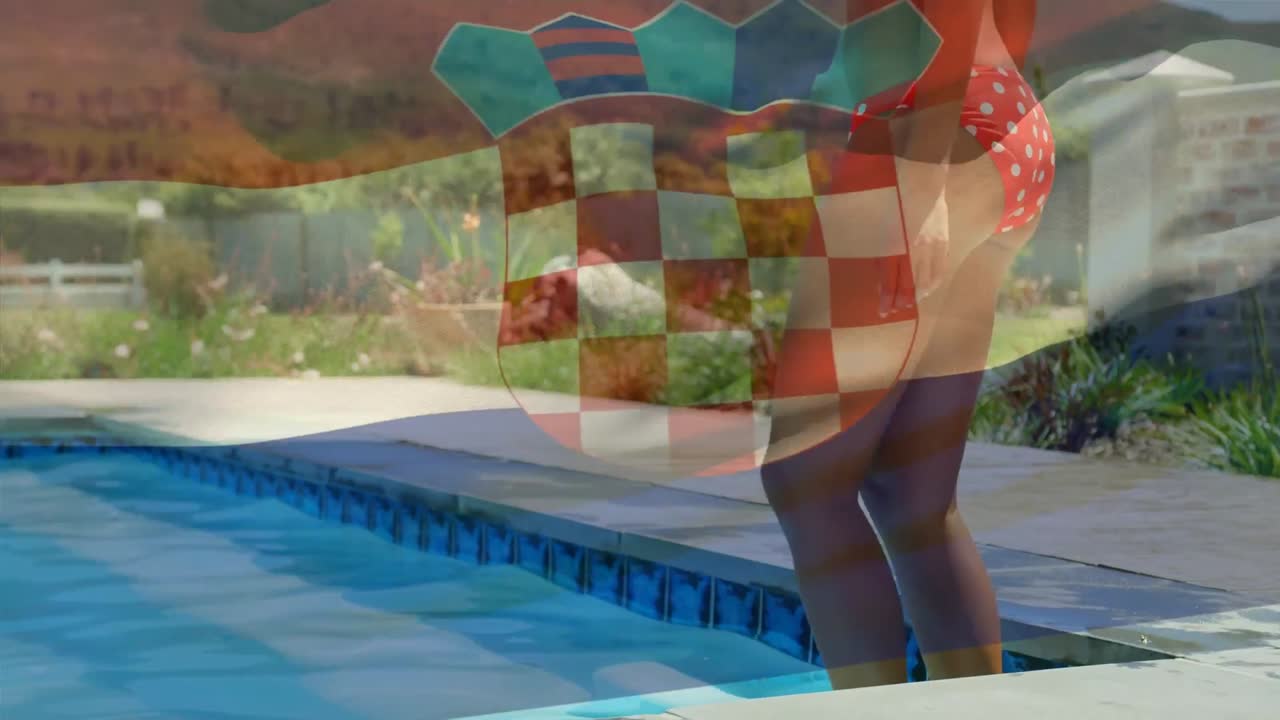 Animation of flag of croatia over midsection of biracial woman walking into swimming pool