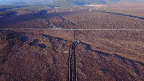 aerial drone shot of vast grassy plains moving towards an rv