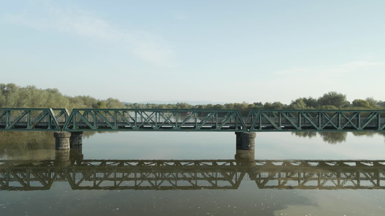 Green Metal Bridge over Calm River