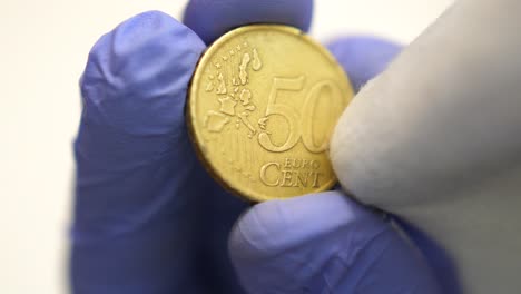 isolated close shot of front fifty cent euro coin wiped, corruption concept