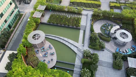 sweeping drone shots of a sleek business park in gurgaon, haryana—glass skyscrapers, landscaped greenery, and urban infrastructure reflecting india’s growing global corporate presence