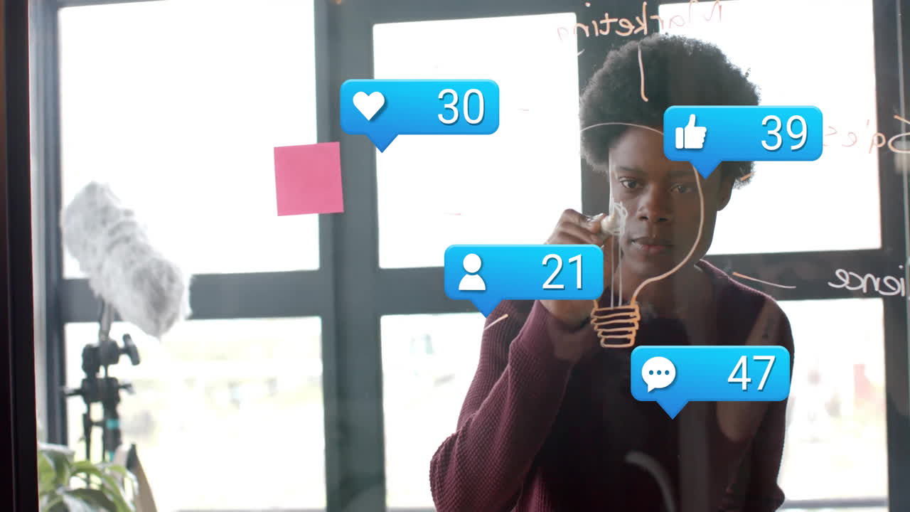 Drawing on glass wall, person creating animation with social media icons in school