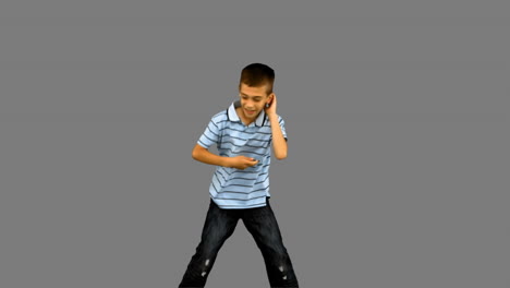 little boy dancing on grey screen