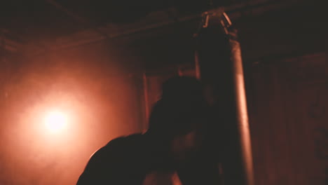 boxer in hoodie warms up by punching the air 2