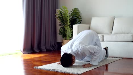 young muslim man praying and practicing the islamic faith