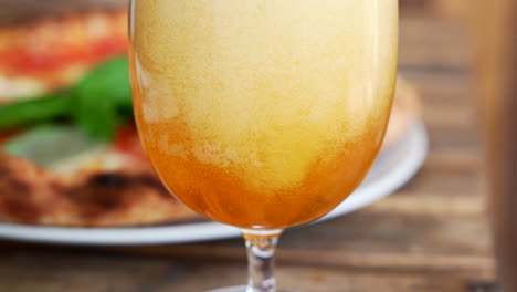 man is pouring beer in a pizzeria, close up on the foam, and bubbles