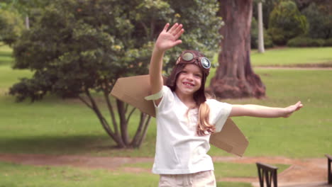 Standing-girl-with-fake-wings-pretending-to-be-pilot