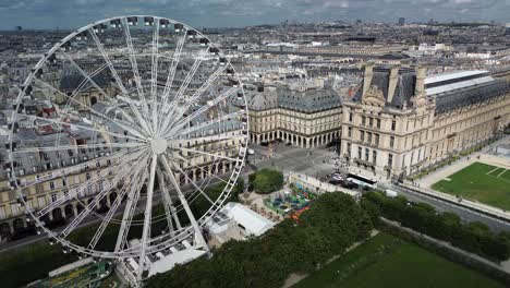 paris cityscape from ferris wheel aerial drone point of view flying backward