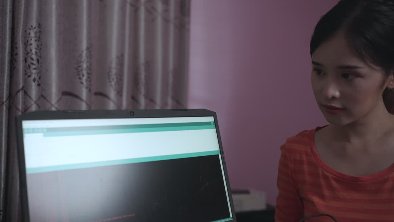 Technician Asian woman assembles electronic circuits with a microcontroller board open-source hardware and software