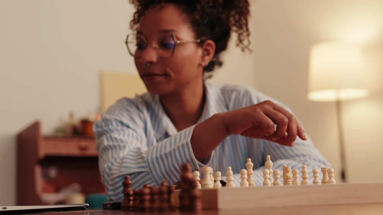 Woman Sets Up Chessboard at Home