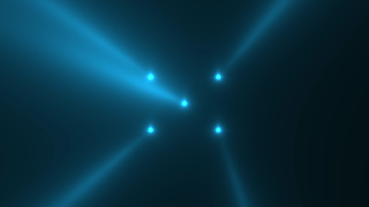 Glowing blue spotlight beams on stage