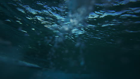 closeup view of glistening ocean water barrel pulling up wave from underwater