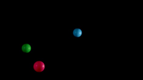 multicolored balls bouncing against a black background