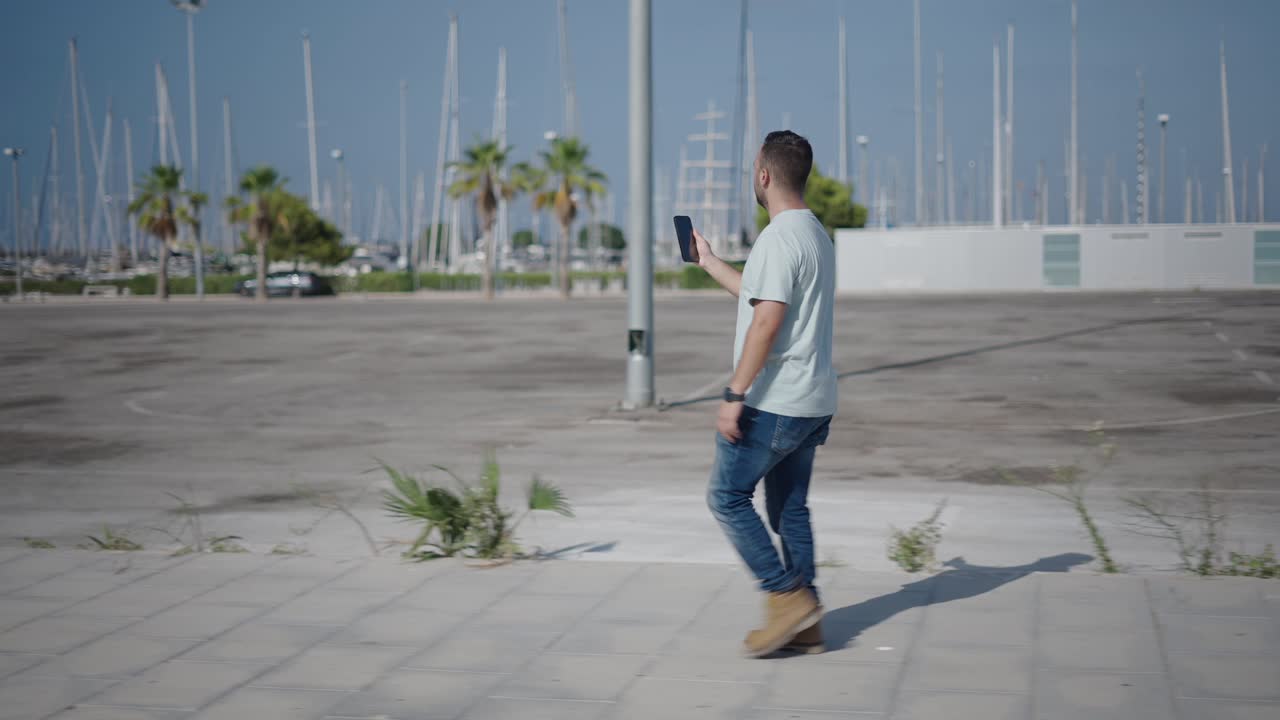 Man Walking Outdoors with Phone