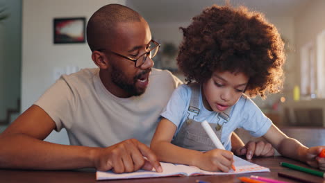 father and child coloring together