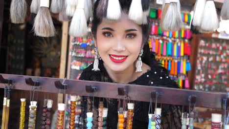 asian woman smiling in souvenir shop, slow motion