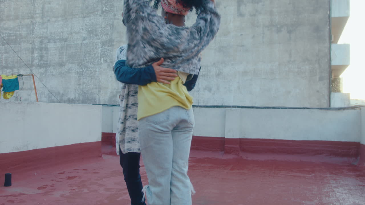 Attractive African-American Woman Dancing Tango with Partner on Urban Rooftop