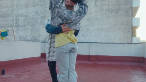 attractive african-american woman dancing tango with partner on urban rooftop