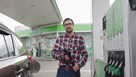 man filling up car at a gas station